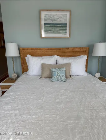 a bedroom with a bed and a lamp on table