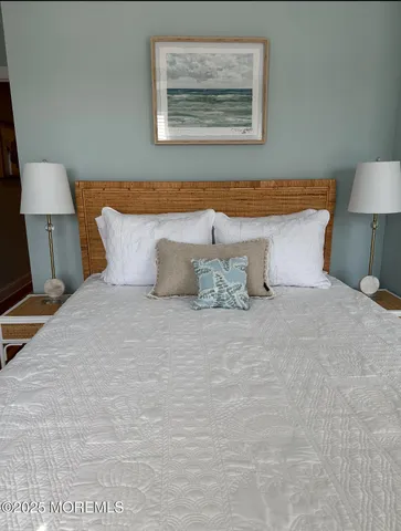 a bedroom with a bed and a lamp on table