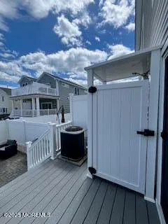 a view of house with deck outdoor seating and barbeque oven