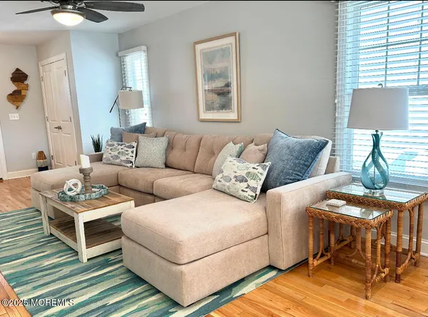 a living room with furniture a lamp and a table