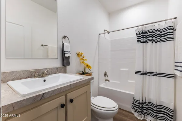 a bathroom with a toilet sink and shower