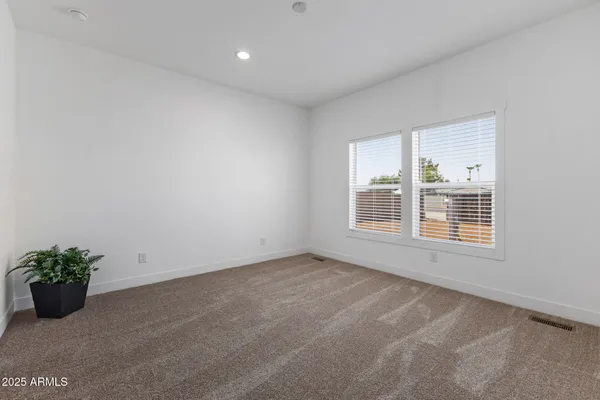 a view of empty room with a kitchen