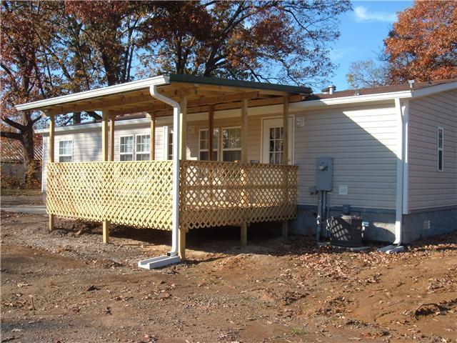 119 Fire Tower Road Dickson, TN 37055 - Photo 2 of 14 Spacios covered back deck steps down on additioal concrete patio.