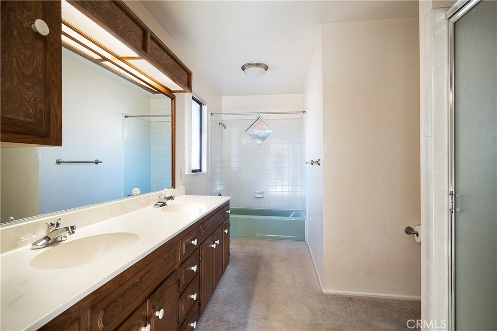 1346 McDonald Road Fallbrook, CA 92028 - Photo 20 of 33 a bathroom with a double vanity sink mirror double and shower