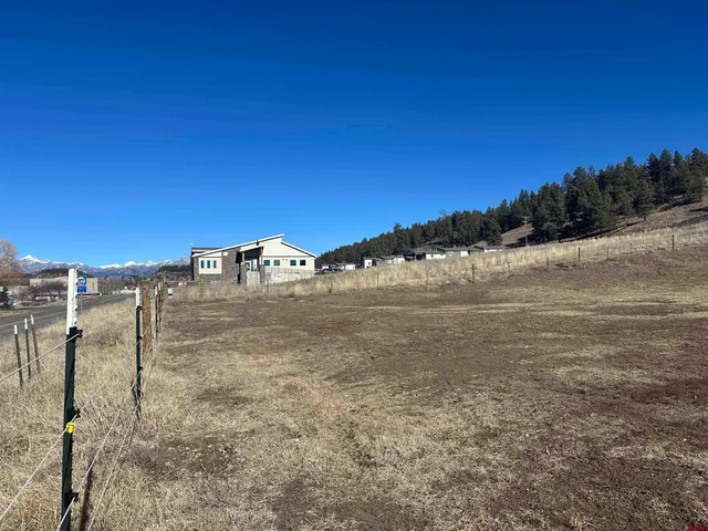 a view of a road with a building in the background