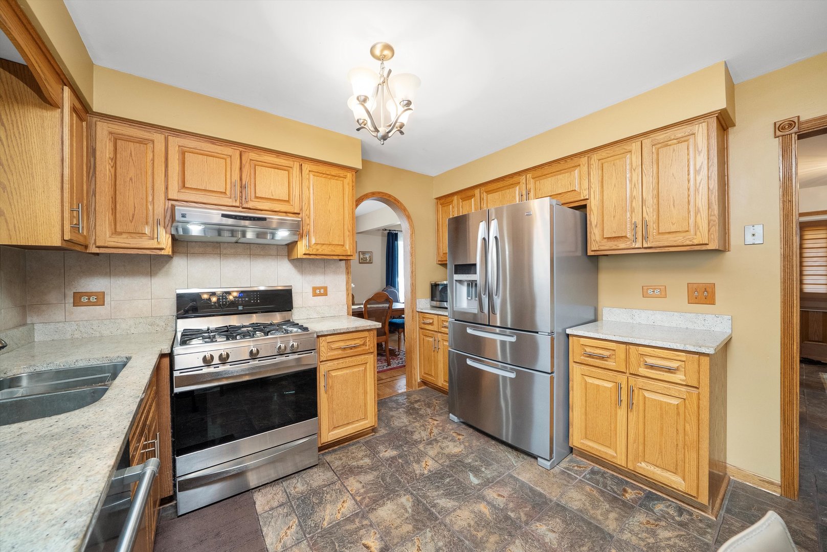 7542 Mason Avenue Burbank, IL 60459 - Photo 13 of 49 a kitchen with stainless steel appliances granite countertop a stove sink and refrigerator