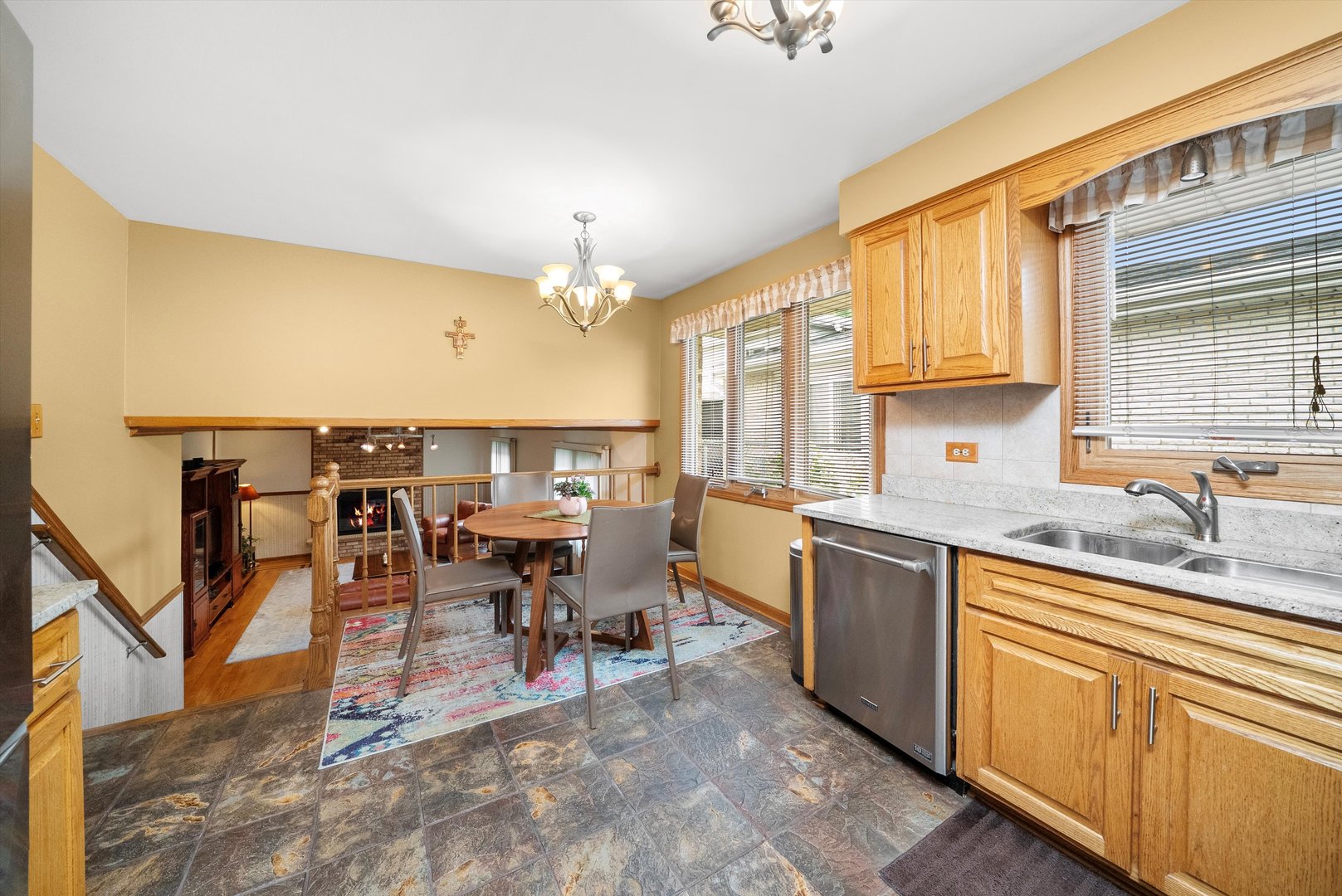 7542 Mason Avenue Burbank, IL 60459 - Photo 14 of 49 a open kitchen with stainless steel appliances granite countertop a dining table chairs sink and cabinets
