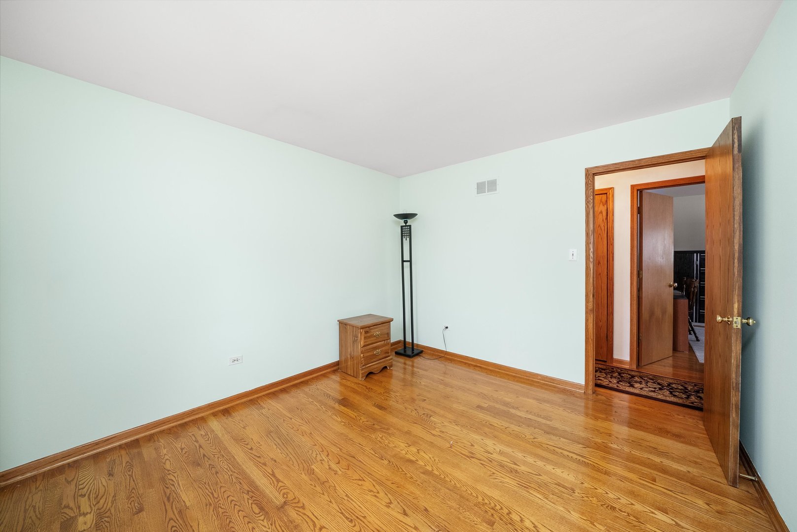 7542 Mason Avenue Burbank, IL 60459 - Photo 23 of 49 a view of a room with wooden floor
