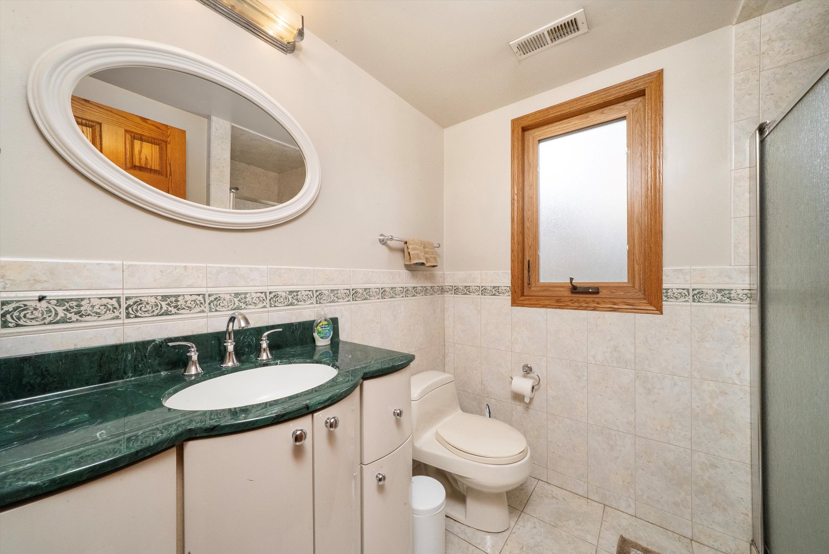 7542 Mason Avenue Burbank, IL 60459 - Photo 25 of 49 a bathroom with a toilet a sink and a mirror