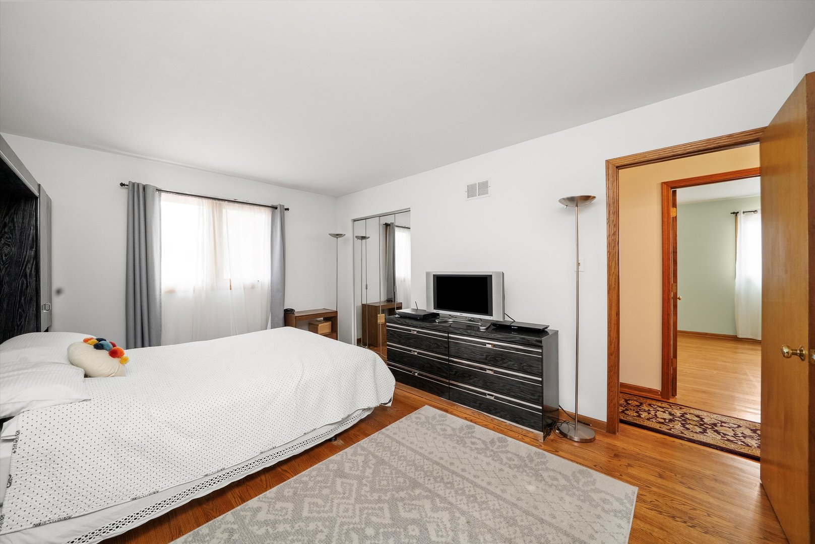 7542 Mason Avenue Burbank, IL 60459 - Photo 29 of 49 a bedroom with a bed and a flat screen tv