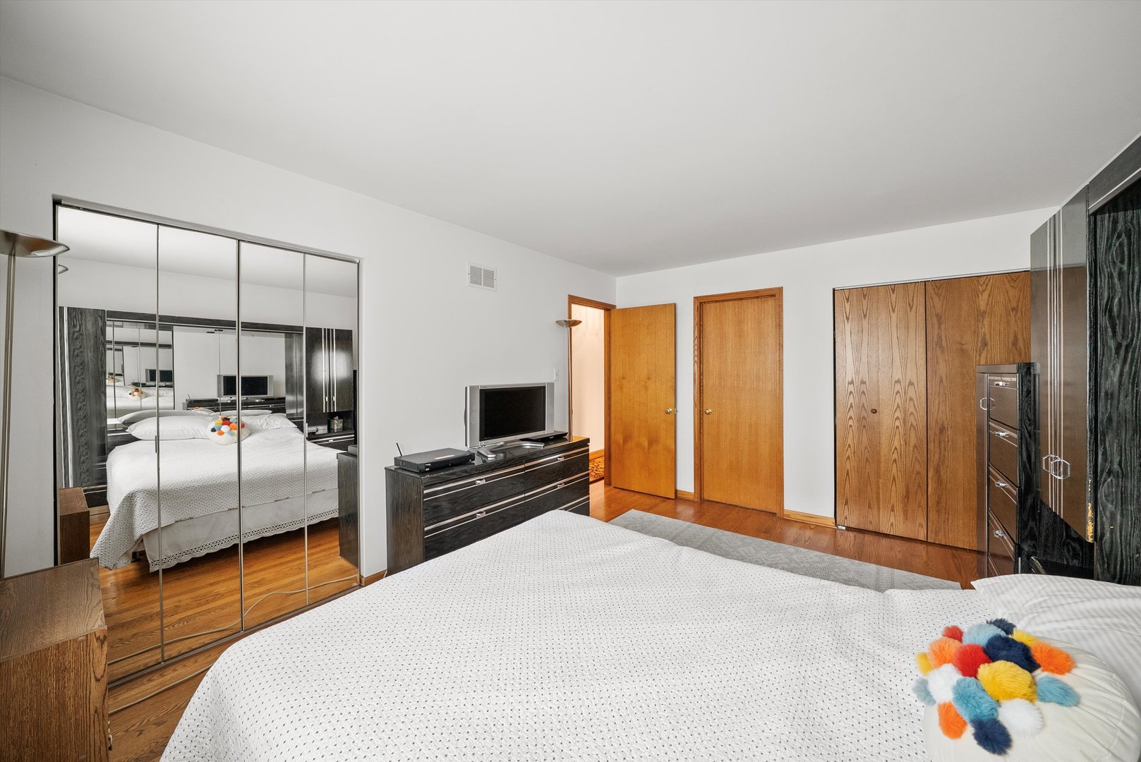 7542 Mason Avenue Burbank, IL 60459 - Photo 30 of 49 a bedroom with bed and wooden floor