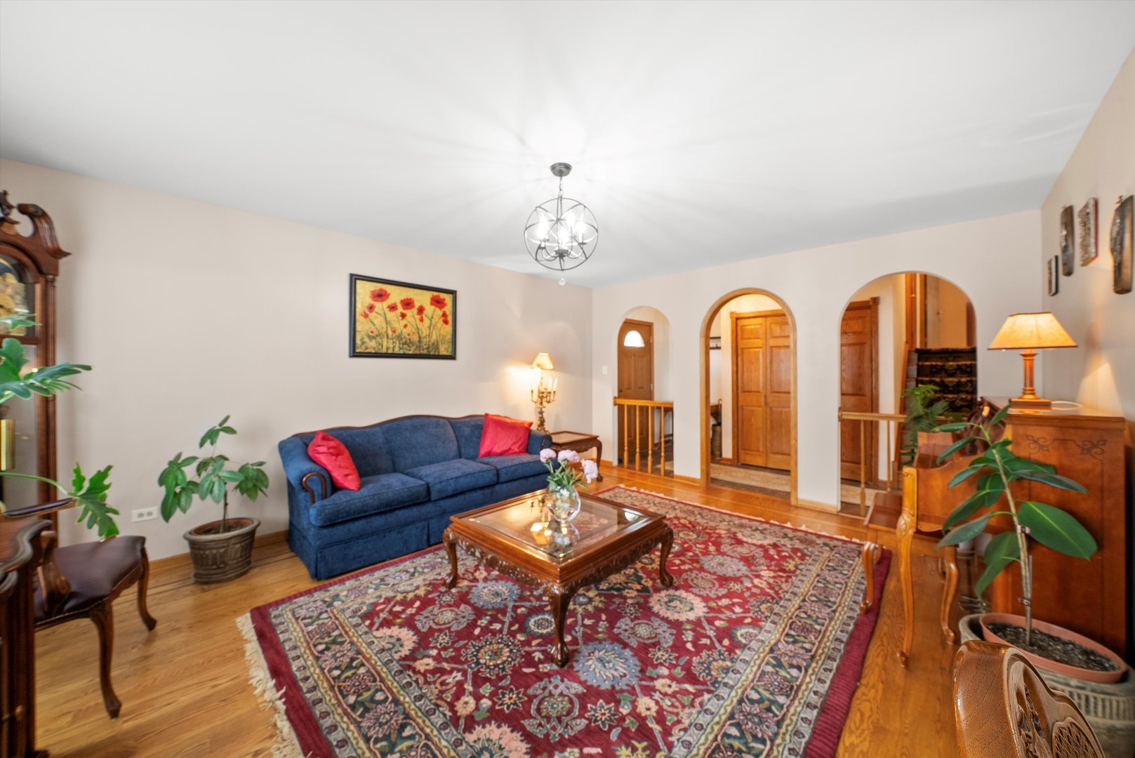 7542 Mason Avenue Burbank, IL 60459 - Photo 3 of 49 a living room with furniture a rug and a chandelier
