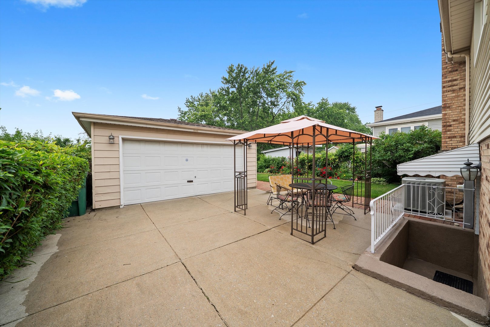 7542 Mason Avenue Burbank, IL 60459 - Photo 34 of 49 a patio with a table and chairs under an umbrella