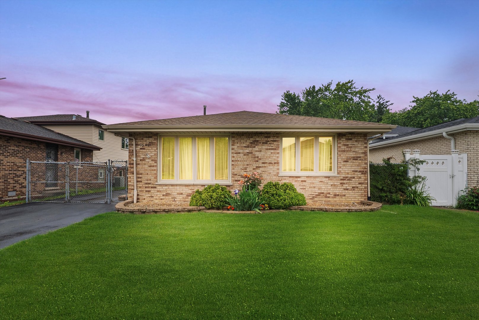 7542 Mason Avenue Burbank, IL 60459 - Photo 39 of 49 a front view of a house with a garden and yard