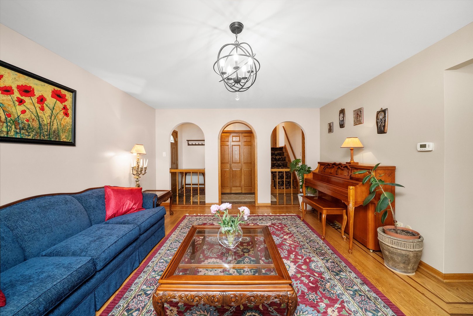 7542 Mason Avenue Burbank, IL 60459 - Photo 4 of 49 a living room with furniture a rug and a chandelier