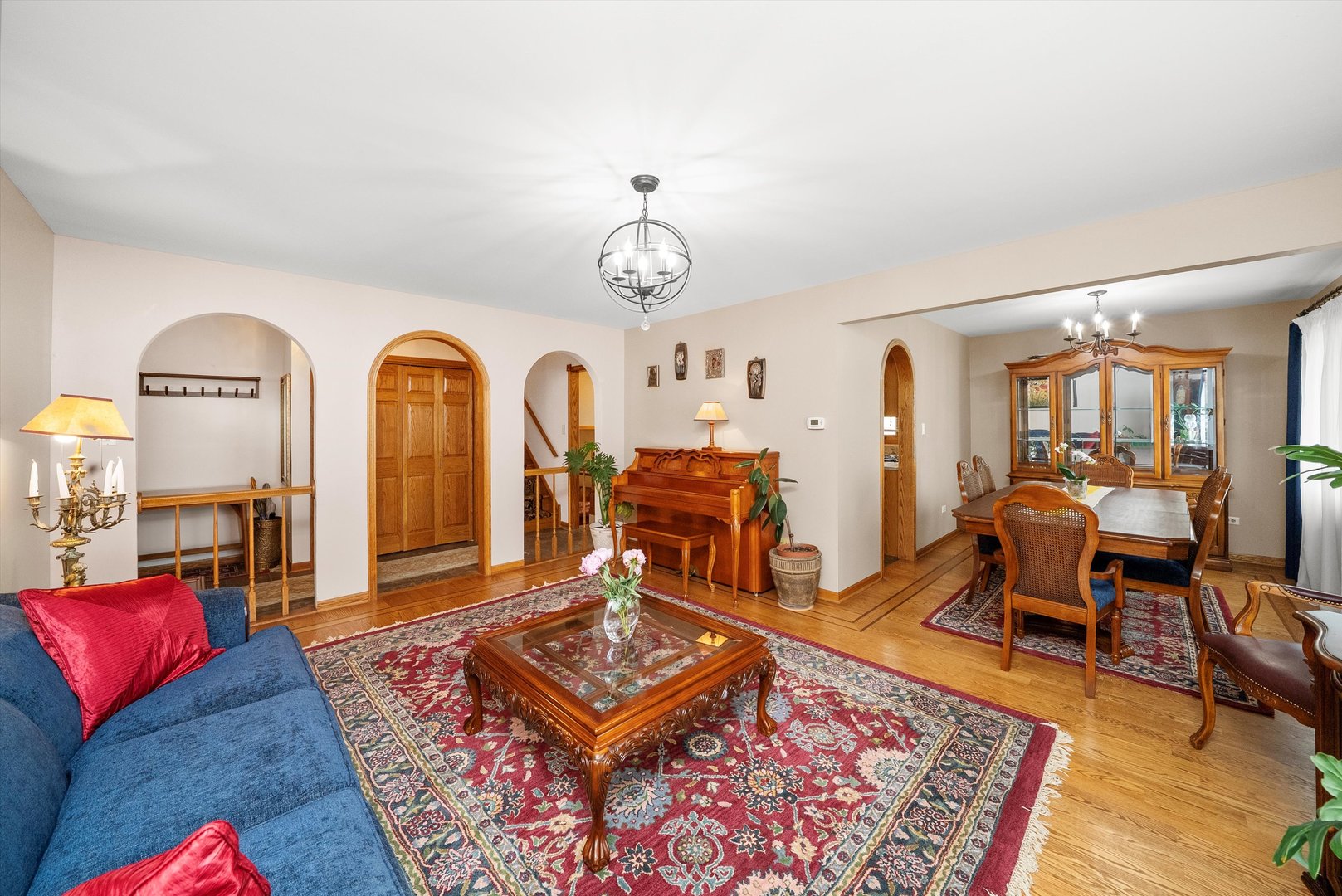 7542 Mason Avenue Burbank, IL 60459 - Photo 5 of 49 a living room with furniture a rug and a chandelier