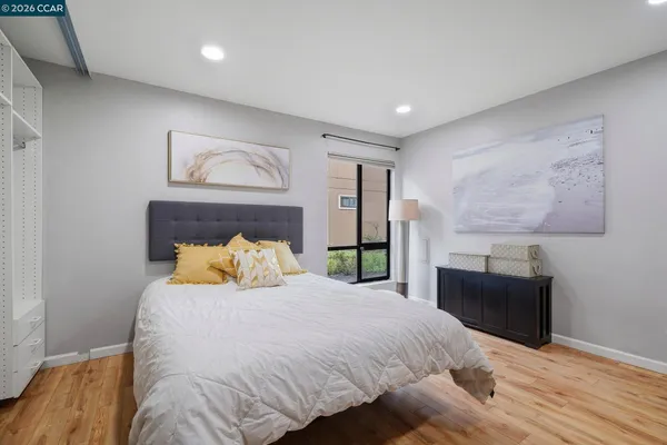 a bedroom with bed and flat screen tv