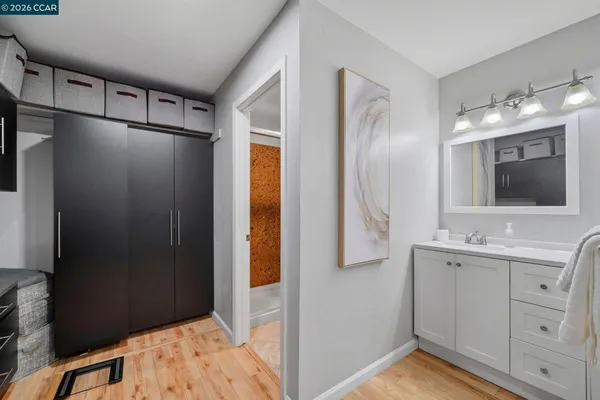 a view of a white house with a yard table and chairs