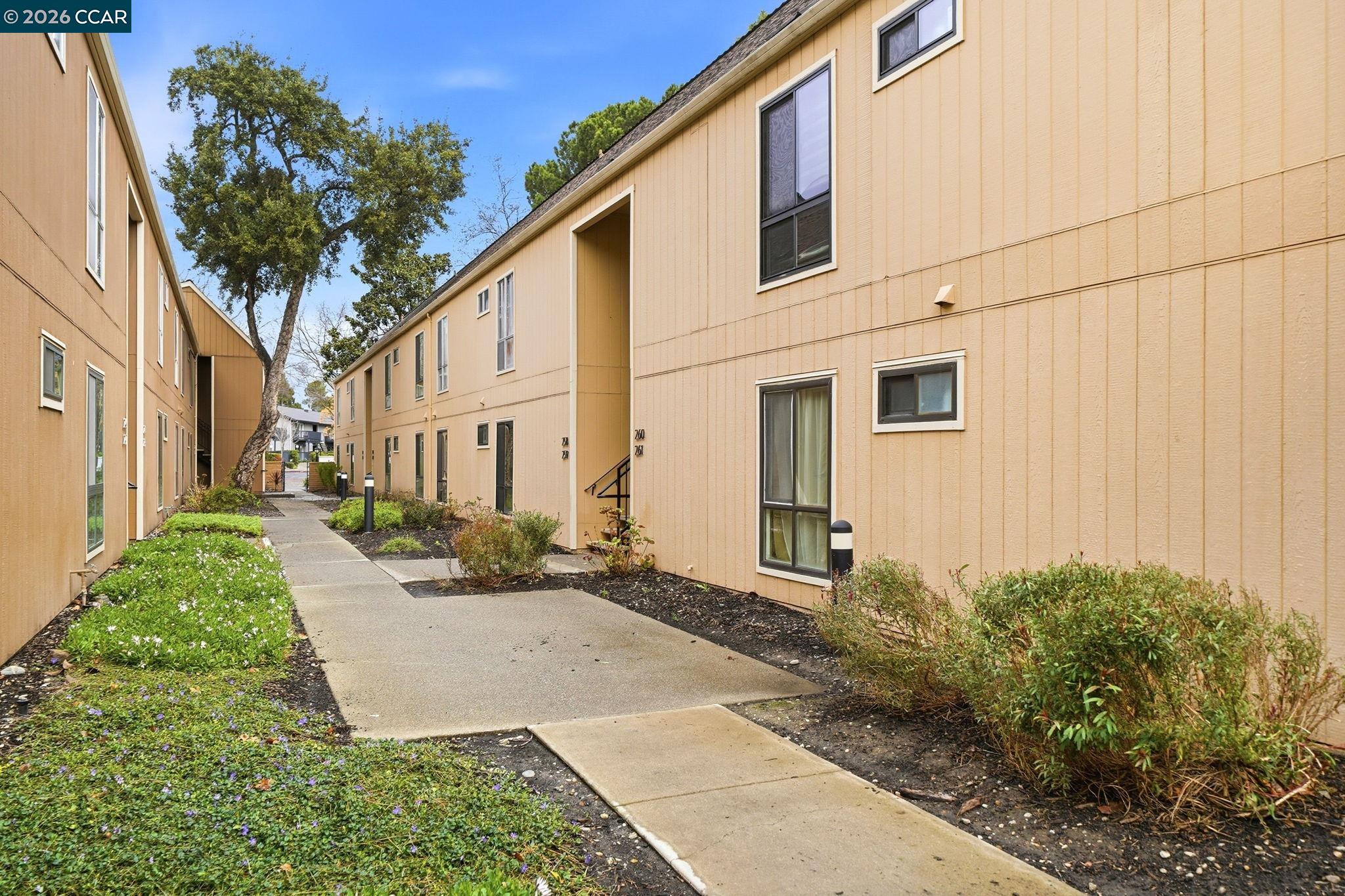 9025 Alcosta Boulevard, Unit 259 San Ramon, CA 94583 - Photo 4 of 40 a view of a white house with a yard