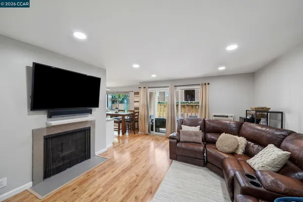 a living room with furniture fireplace and flat screen tv