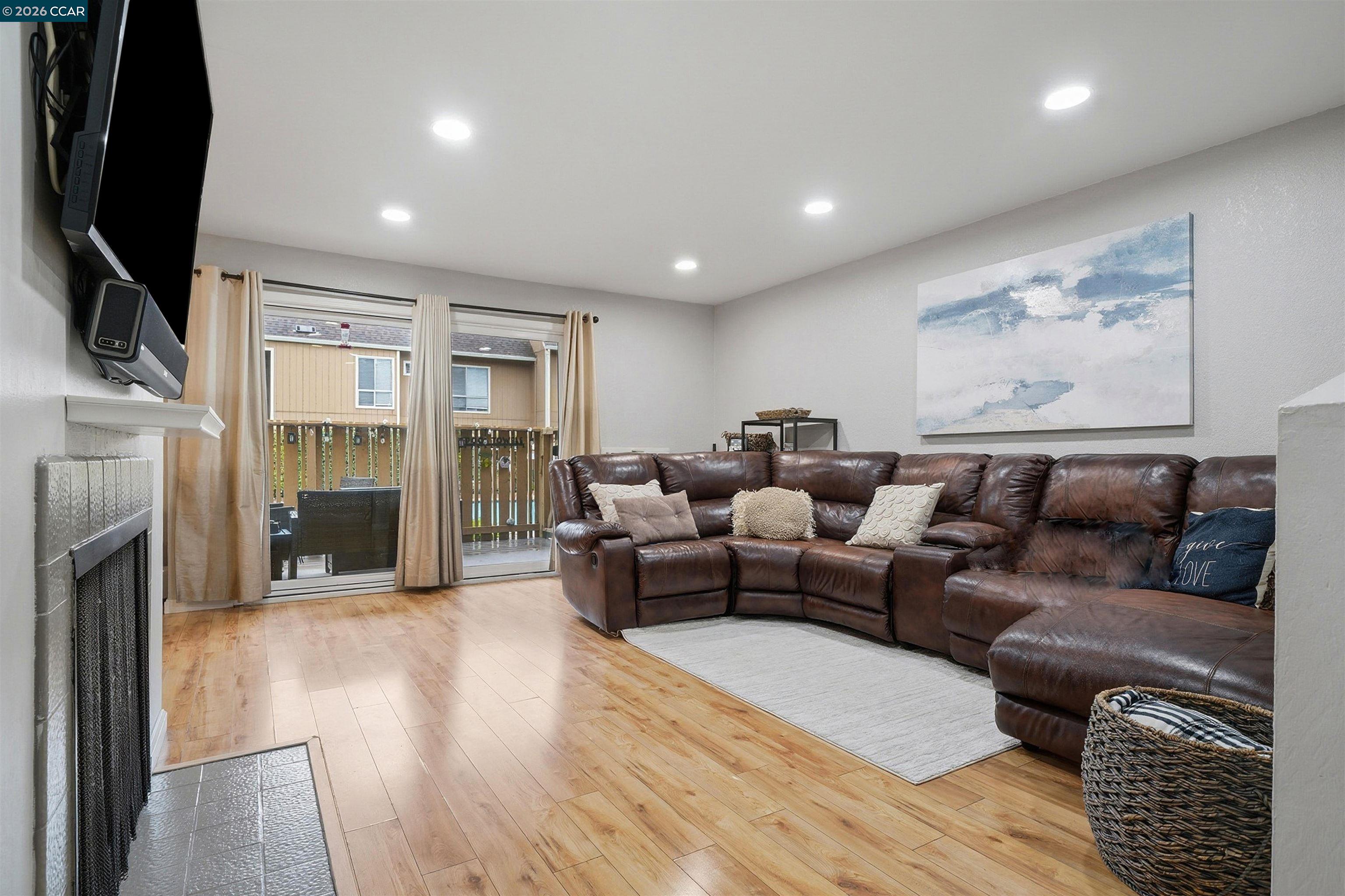 9025 Alcosta Boulevard, Unit 259 San Ramon, CA 94583 - Photo 6 of 40 a living room with furniture fireplace and flat screen tv