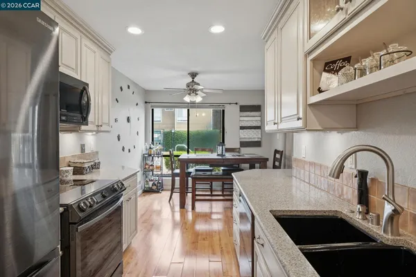 a kitchen with a stove a microwave and wooden floor