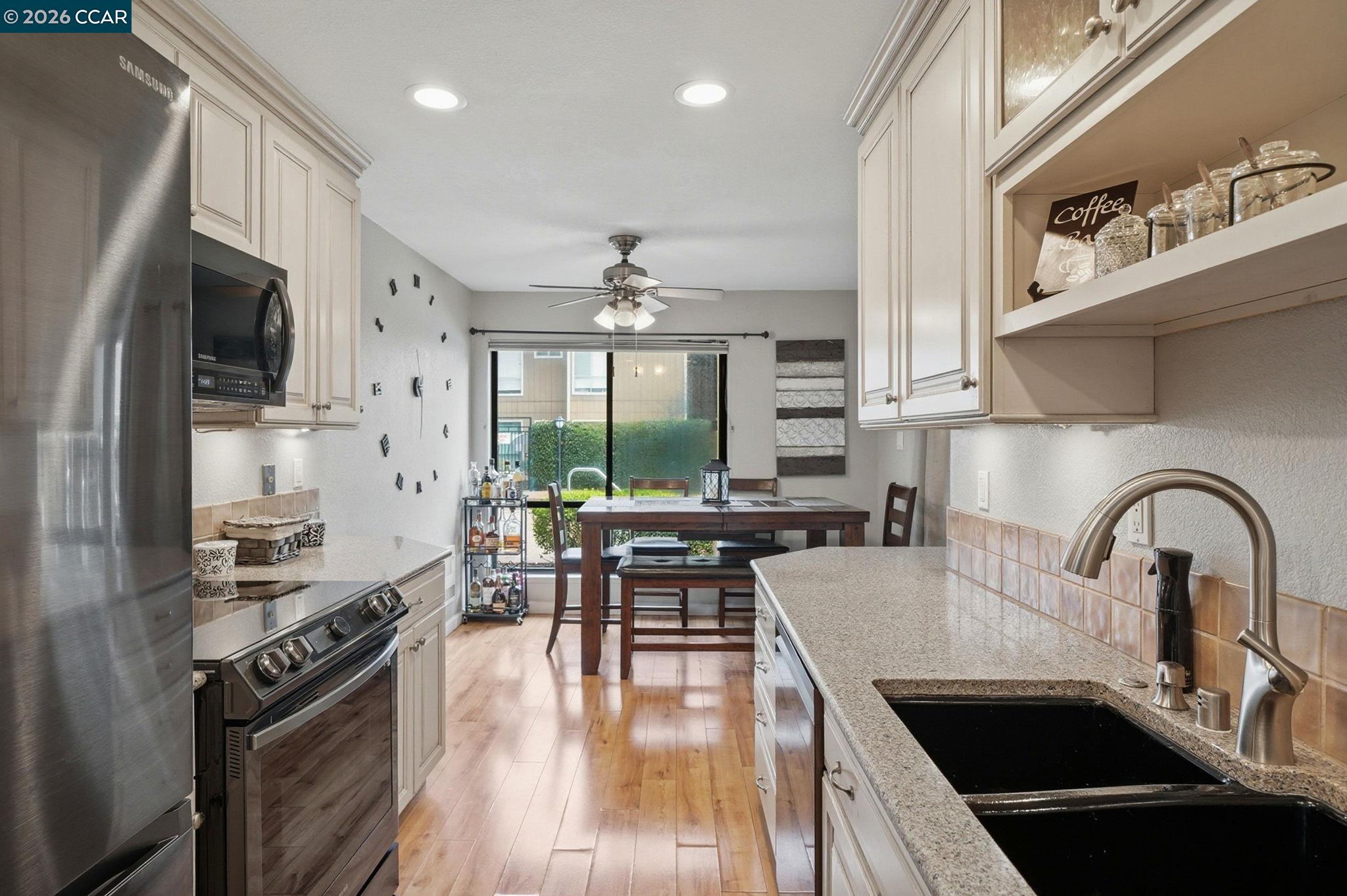 9025 Alcosta Boulevard, Unit 259 San Ramon, CA 94583 - Photo 9 of 40 a kitchen with stainless steel appliances a sink a stove top oven a counter space and cabinets