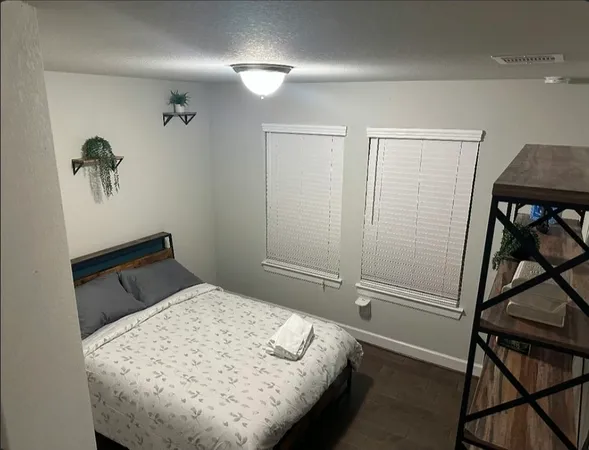 a bedroom with a bed and a window
