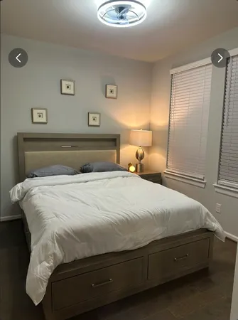 a bedroom with a bed and a lamp