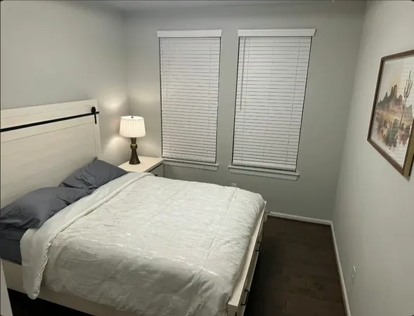 a bed room with a bed and a night stand