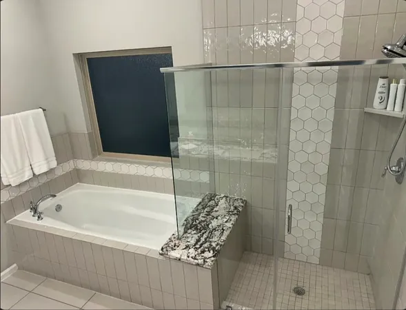 a bathroom with a bathtub and shower