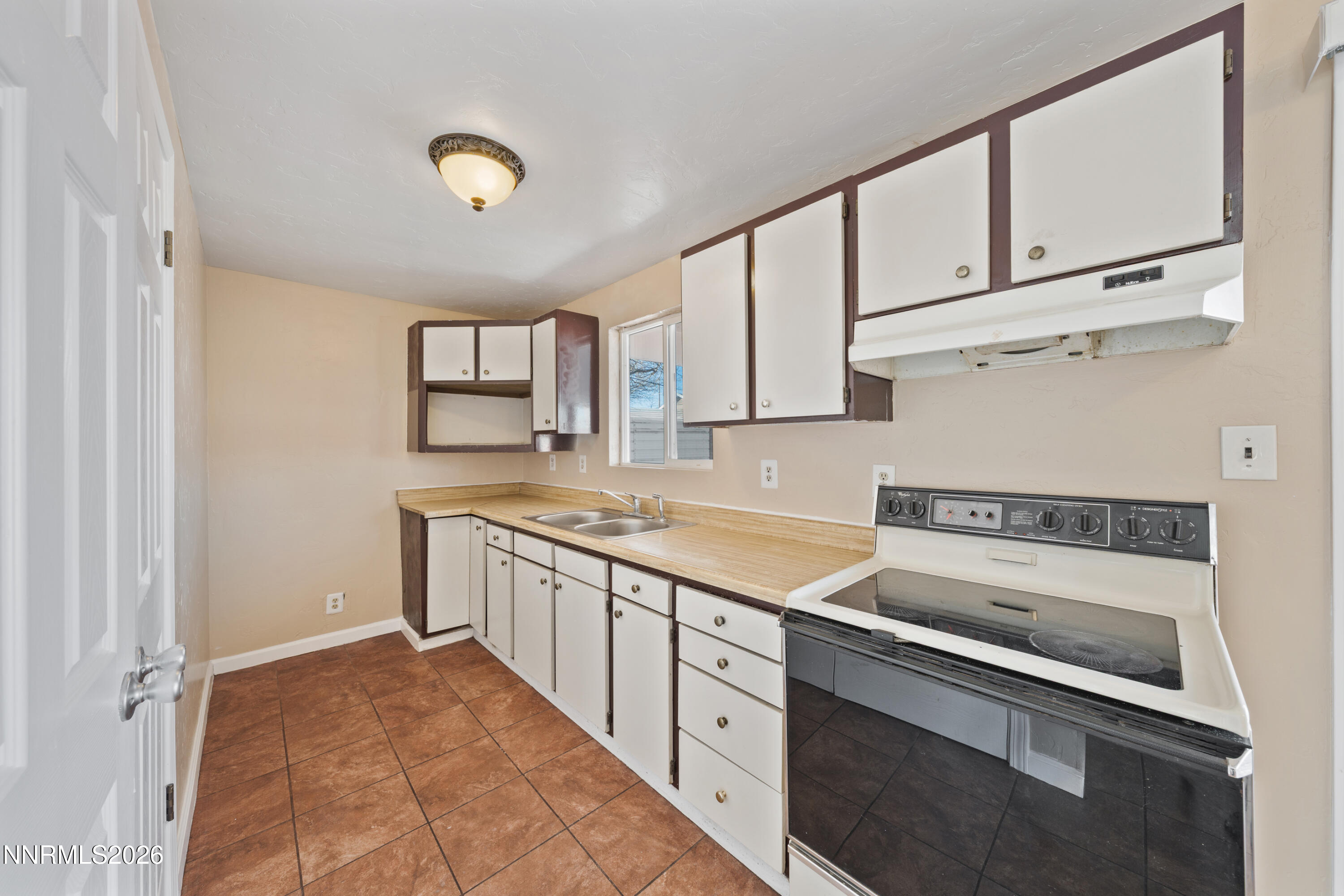 9035 Fremont Way Reno, NV 89506 - Photo 11 of 44 a kitchen with granite countertop a sink stainless steel appliances and cabinets