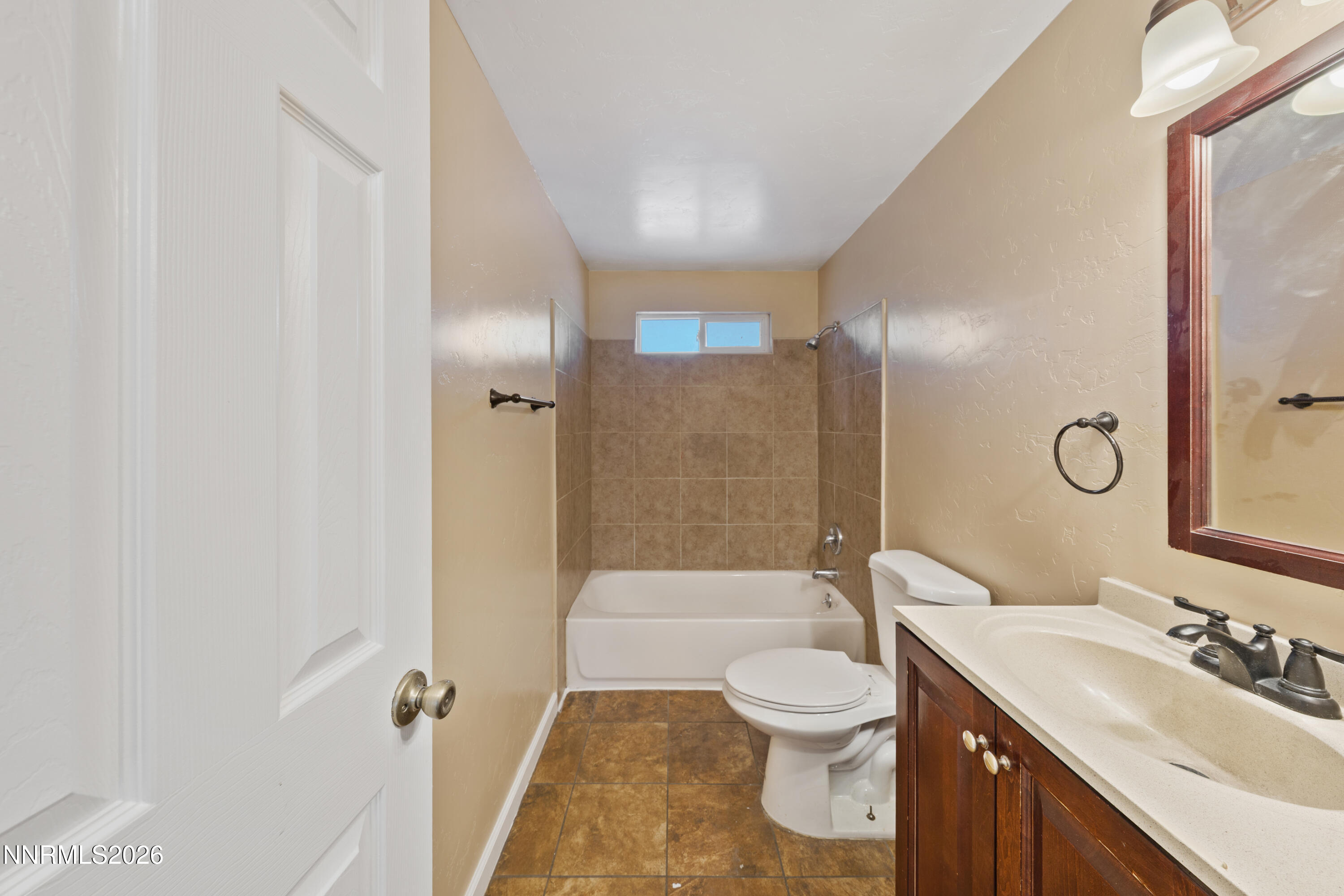 9035 Fremont Way Reno, NV 89506 - Photo 23 of 44 a bathroom with a double vanity sink toilet mirror and shower