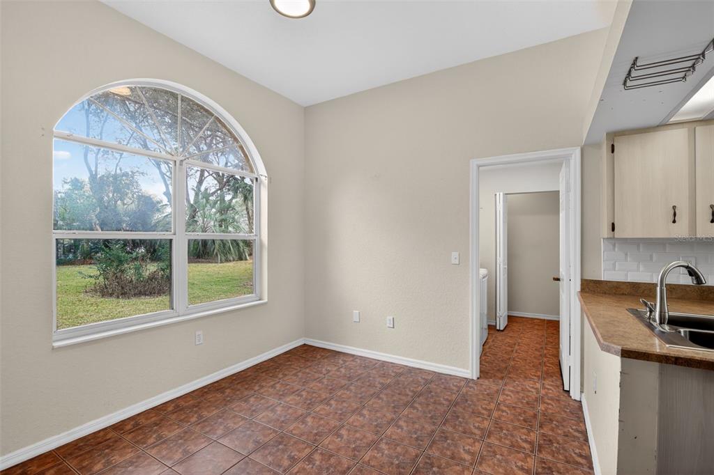11443 Southwest 78th Circle Ocala, FL 34476 - Photo 12 of 33 an empty room with a fireplace and windows