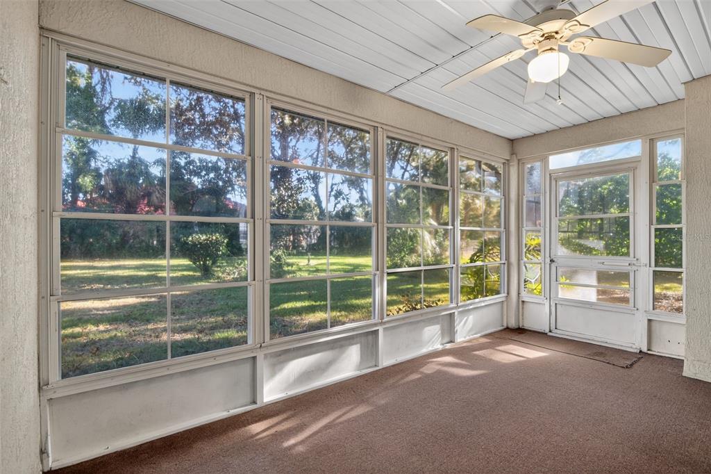 11443 Southwest 78th Circle Ocala, FL 34476 - Photo 28 of 33 a view of a room with a large window and chandelier