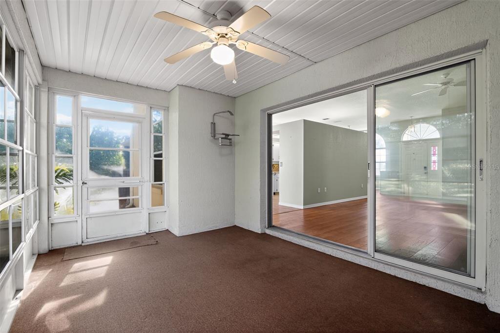 11443 Southwest 78th Circle Ocala, FL 34476 - Photo 29 of 33 a view of a big room with a chandelier fan and windows