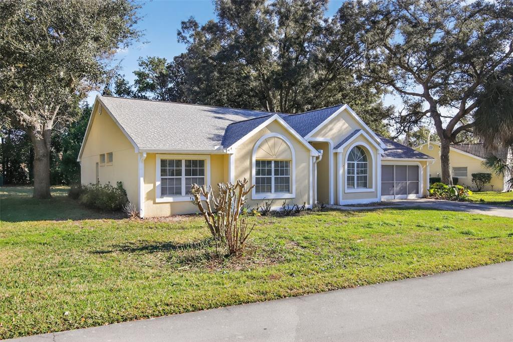 11443 Southwest 78th Circle Ocala, FL 34476 - Photo 30 of 33 a front view of a house with garden