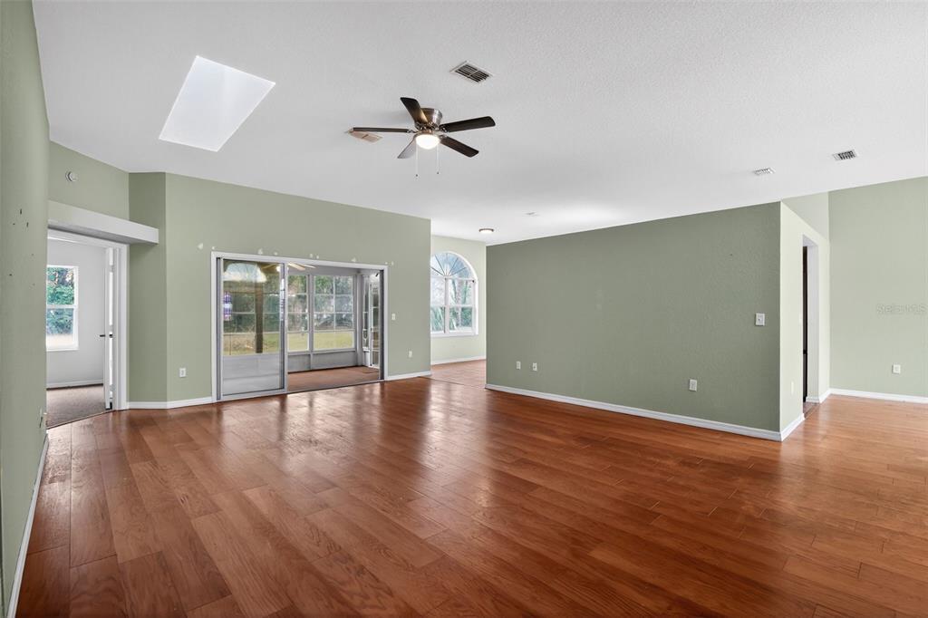 11443 Southwest 78th Circle Ocala, FL 34476 - Photo 3 of 33 a view of an empty room with wooden floor and a window