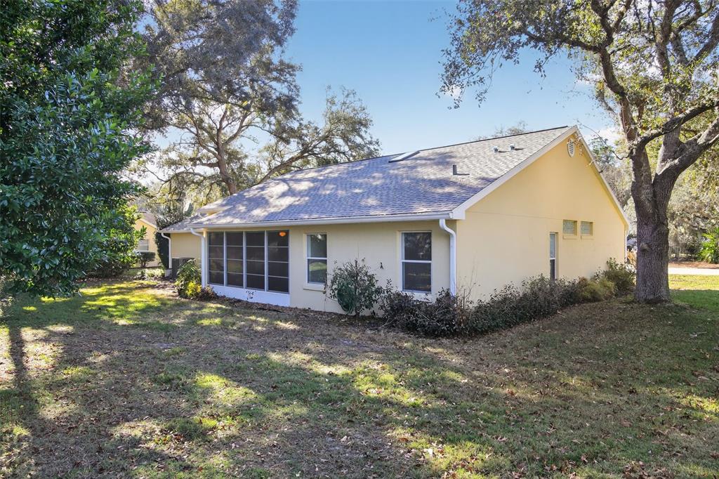11443 Southwest 78th Circle Ocala, FL 34476 - Photo 31 of 33 a front view of a house with a yard and trees