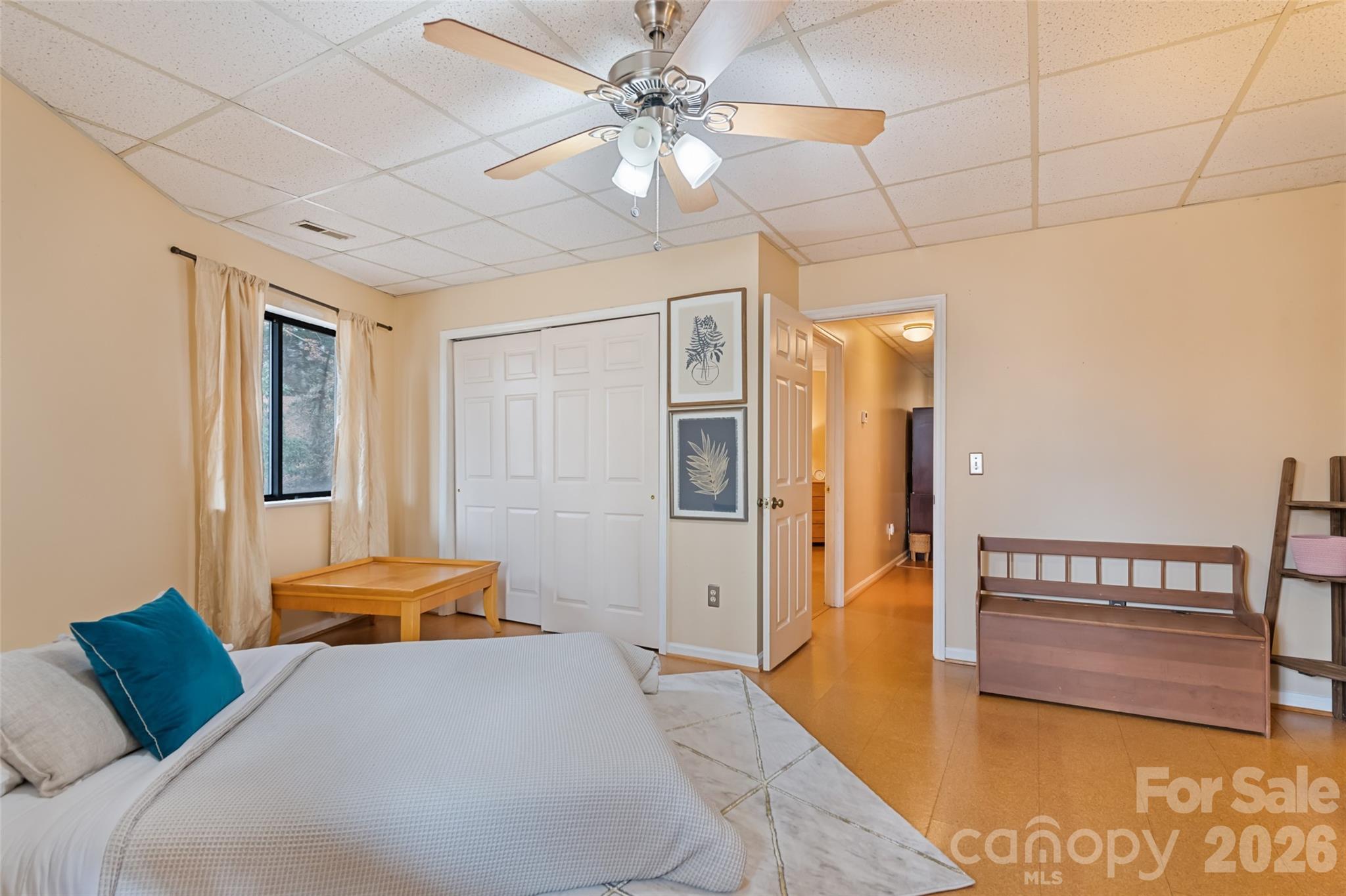 12 Shady Lane Candler, NC 28715 - Photo 16 of 21 a bedroom with a bed and a chandelier