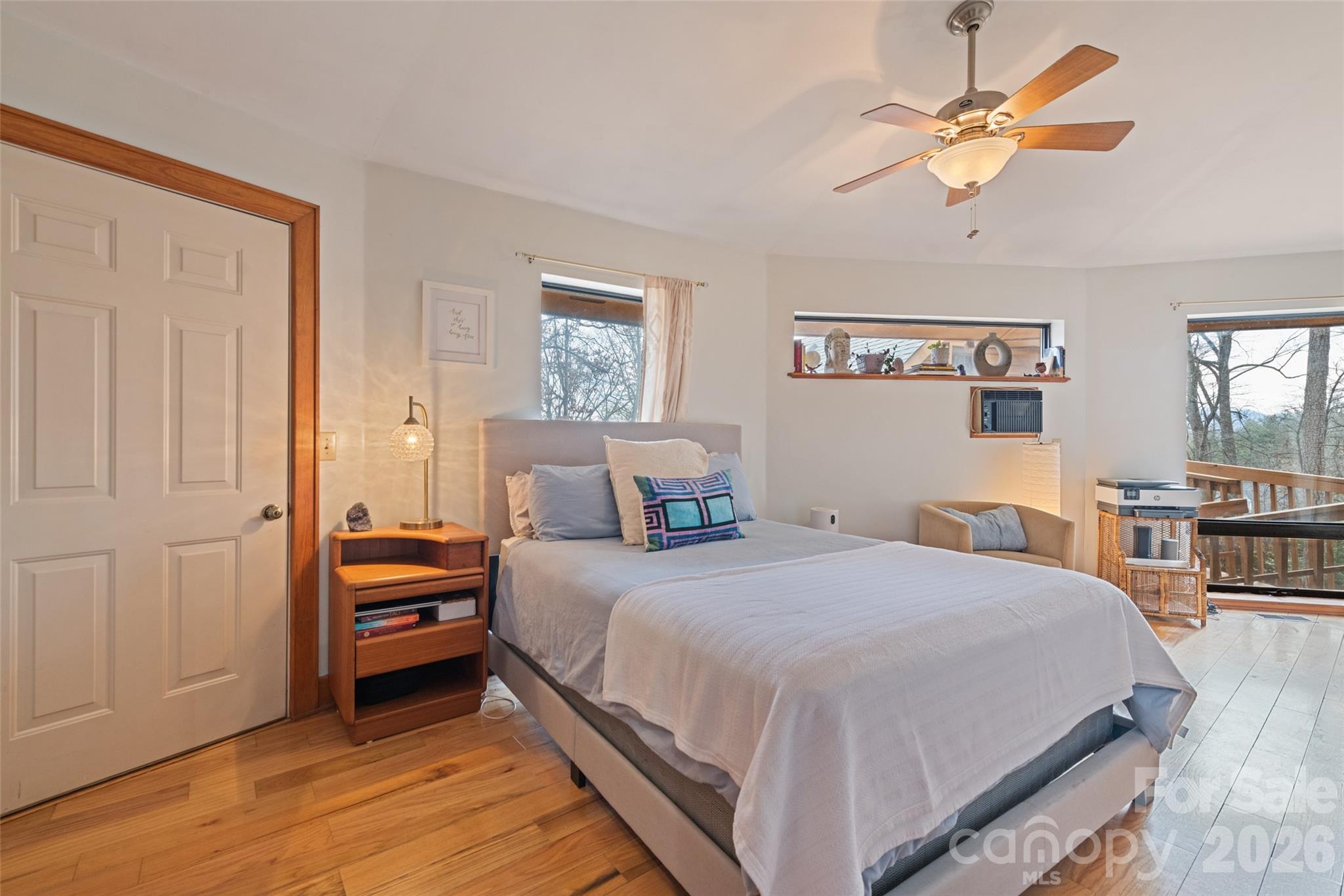 12 Shady Lane Candler, NC 28715 - Photo 7 of 21 a bedroom with a bed and a chandelier