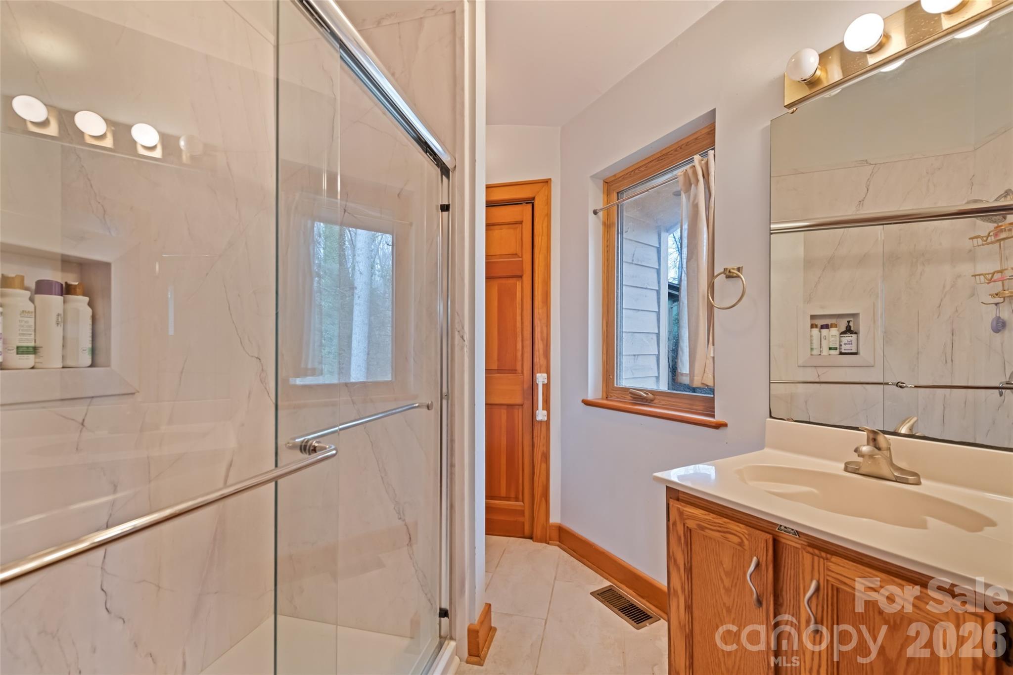 12 Shady Lane Candler, NC 28715 - Photo 8 of 21 a bathroom with a sink and a mirror