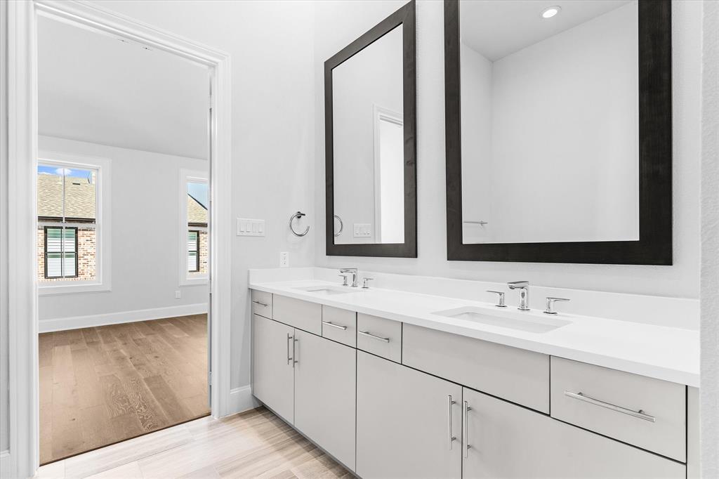 5029 Magnolia Street Addison, TX 75001 - Photo 12 of 25 Full bath featuring double vanity and light wood-style floors