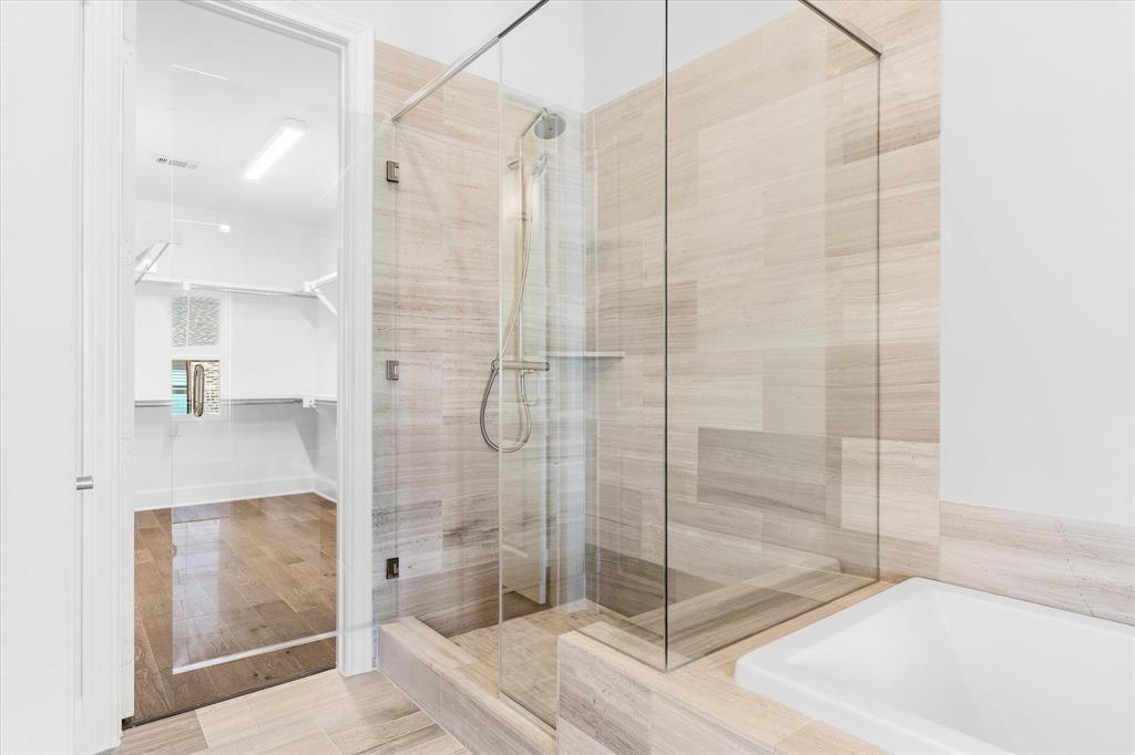 5029 Magnolia Street Addison, TX 75001 - Photo 13 of 25 Full bath with a stall shower, a garden tub, a spacious closet, and light wood-type flooring