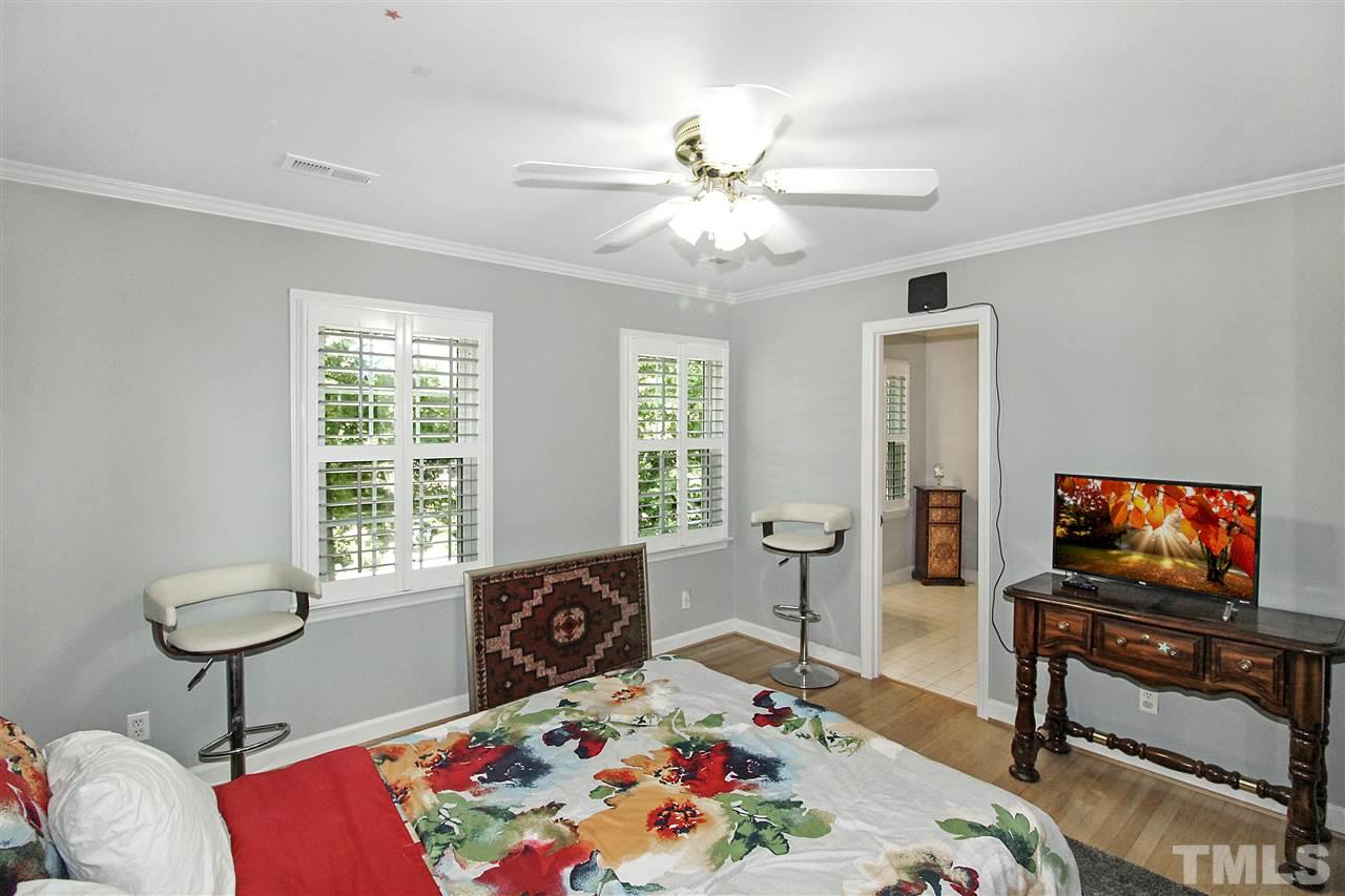 1408 Hunting Ridge Road Raleigh, NC 27615 - Photo 14 of 25 a bedroom with furniture and a flat screen tv