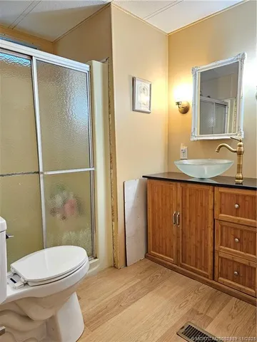 a bathroom with a granite countertop toilet sink and shower