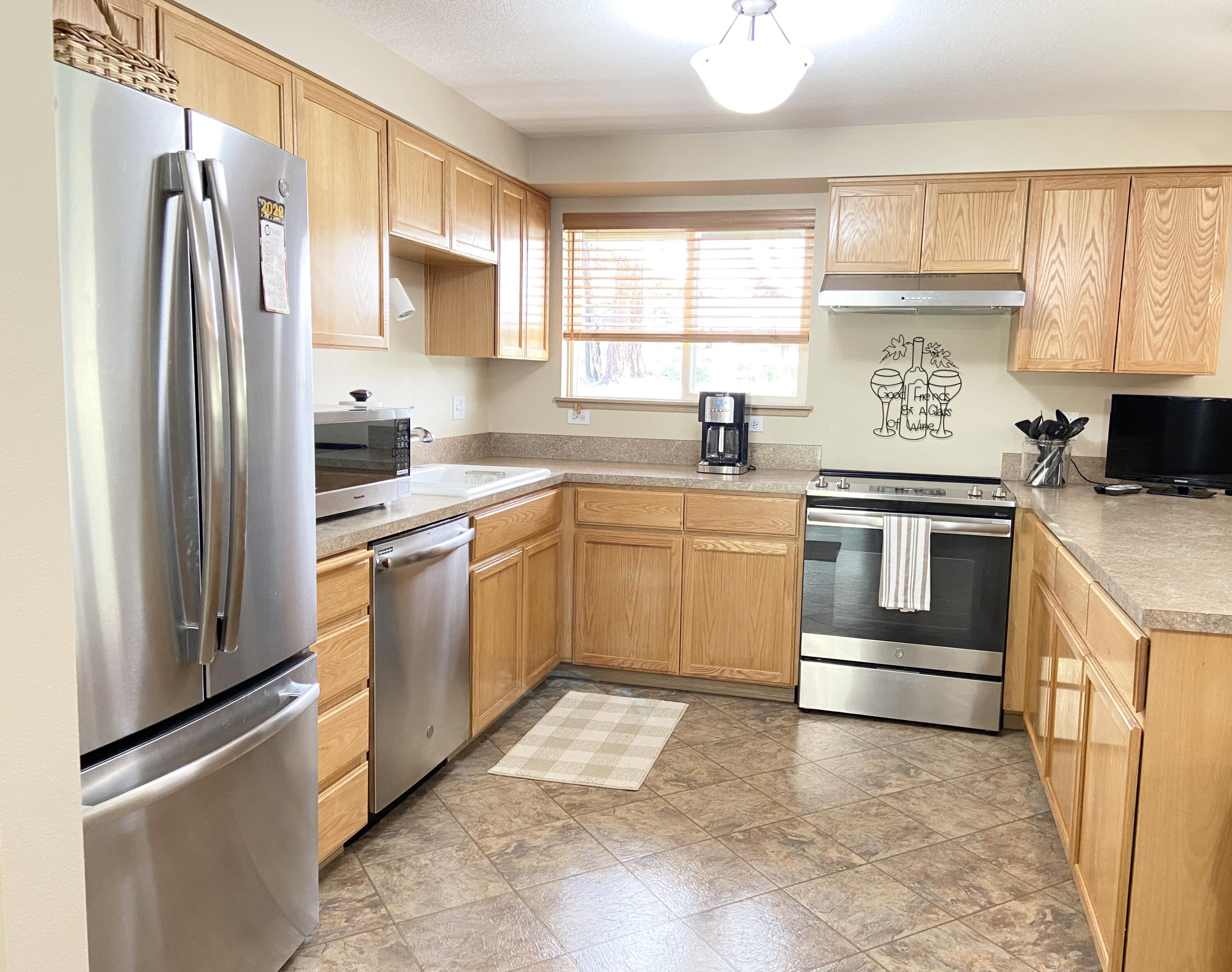60218 Agate Road Bend, OR 97702 - Photo 6 of 19 a kitchen with a stove sink and refrigerator