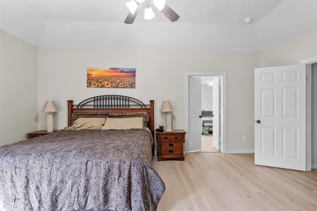 a bedroom with a bed and a chandelier