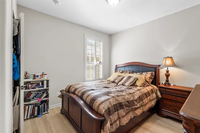 a bedroom with a bed and a book shelf