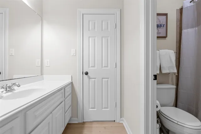 a bathroom with a sink a toilet a tub and shower
